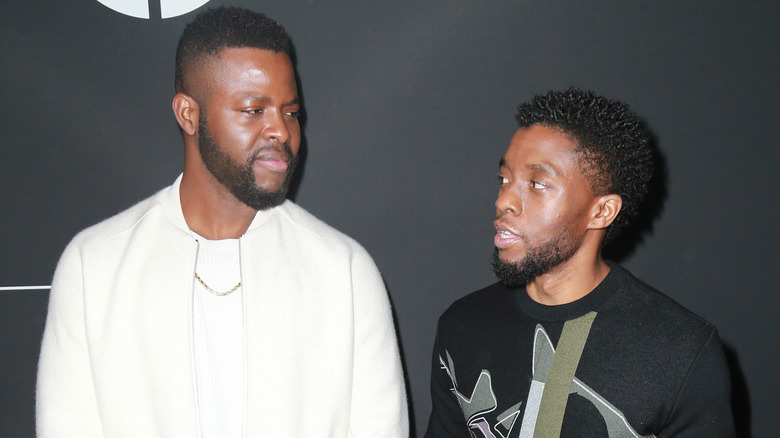 Winston Duke and Chadwick Boseman speaking