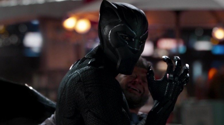 T'Challa with claws bared holding Klaue