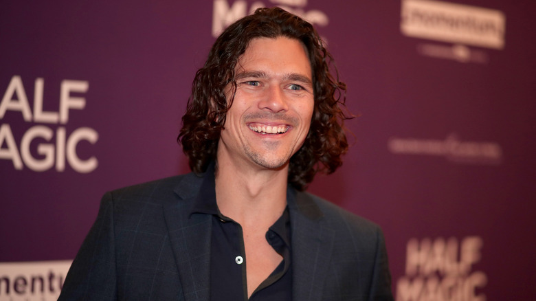 Luke Arnold attends a premiere