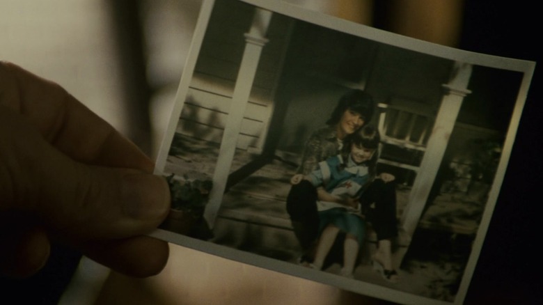 Deckard looks at photo of mother and child