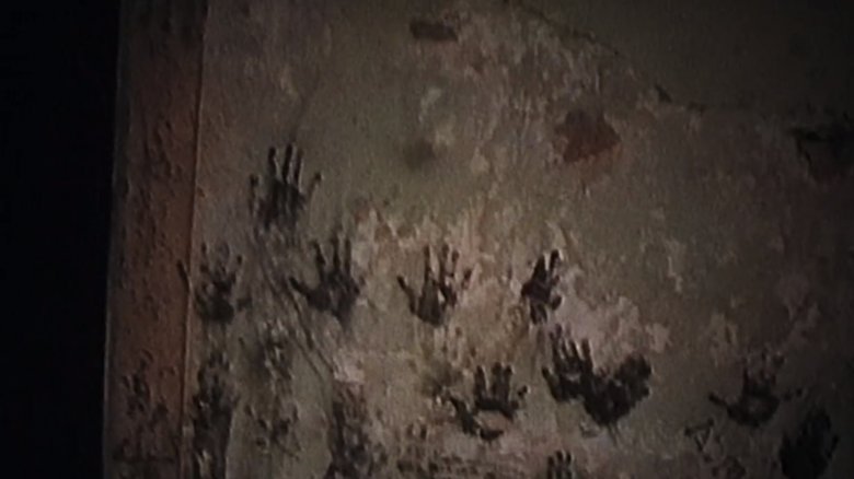 Child size handprints on a wall