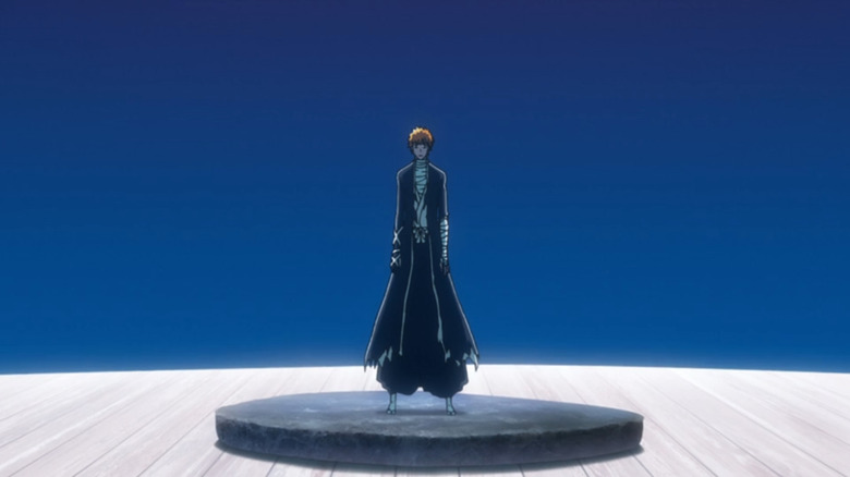 Ichigo stands on a black platform with a blue background 