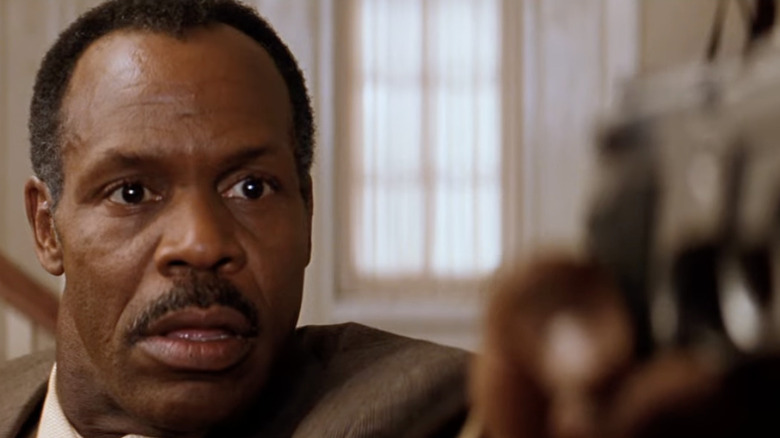 Danny Glover points gun