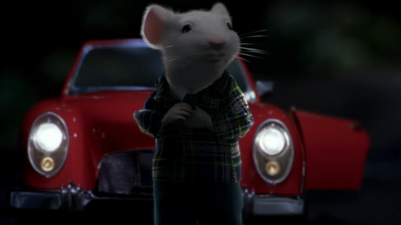 Stuart Little stands by car