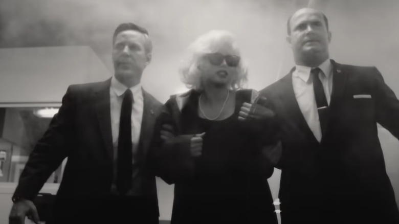 Secret service agents take Marilyn Monroe through a hotel