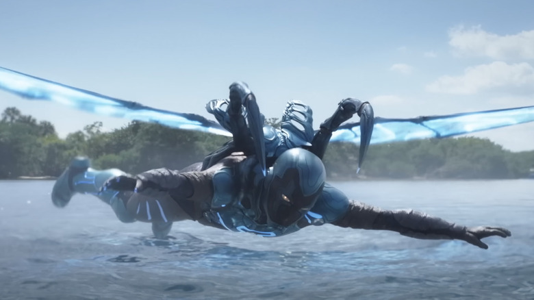 Blue Beetle hovering over water