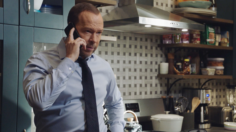 Danny Reagan talking on the phone in his kitchen on "Blue Bloods"