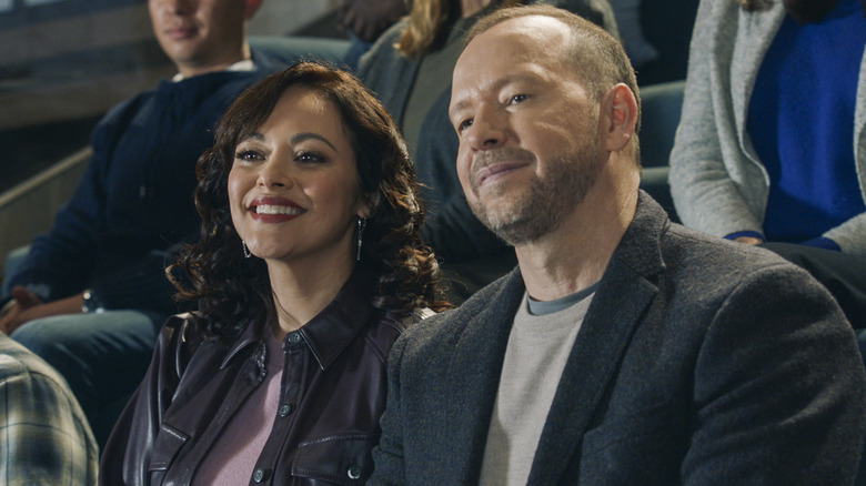 Maria Baez and Danny Reagan smiling in audience on Blue Bloods