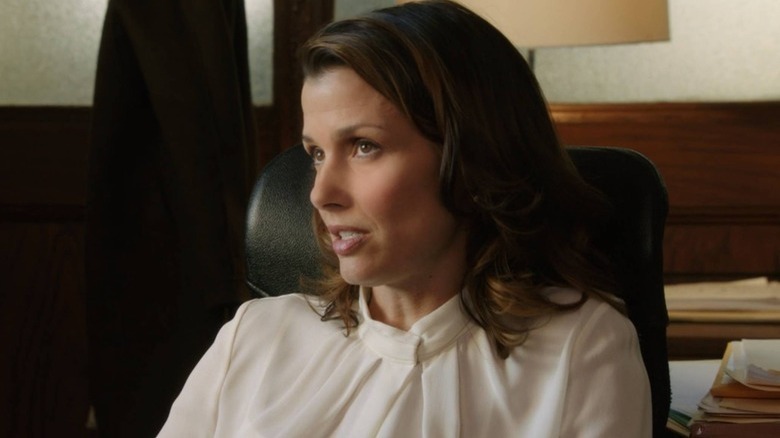 Bridget Moynahan leans back in a chair