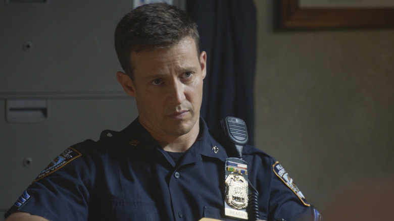 Will Estes sits behind a desk