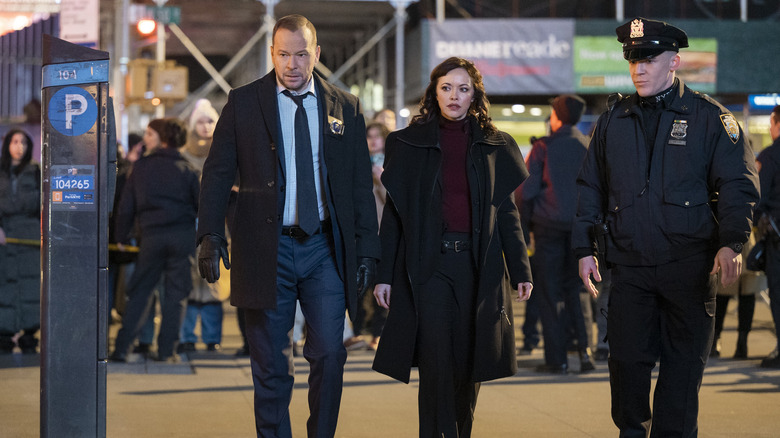 Danny Reagan, Det. Maria Baez, and a uniformed police officer walking and talking 