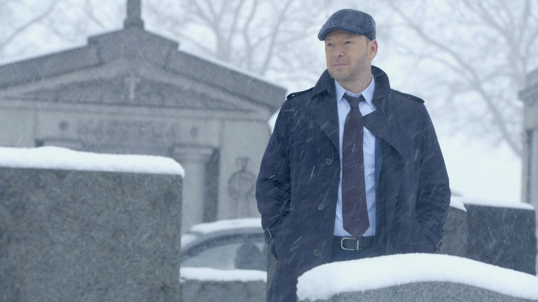 Donnie Wahlberg looking at grave