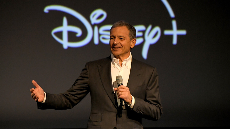 Bob Iger in front of Disney+ logo