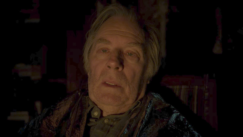 Chuck McGill wearing space blanket in home