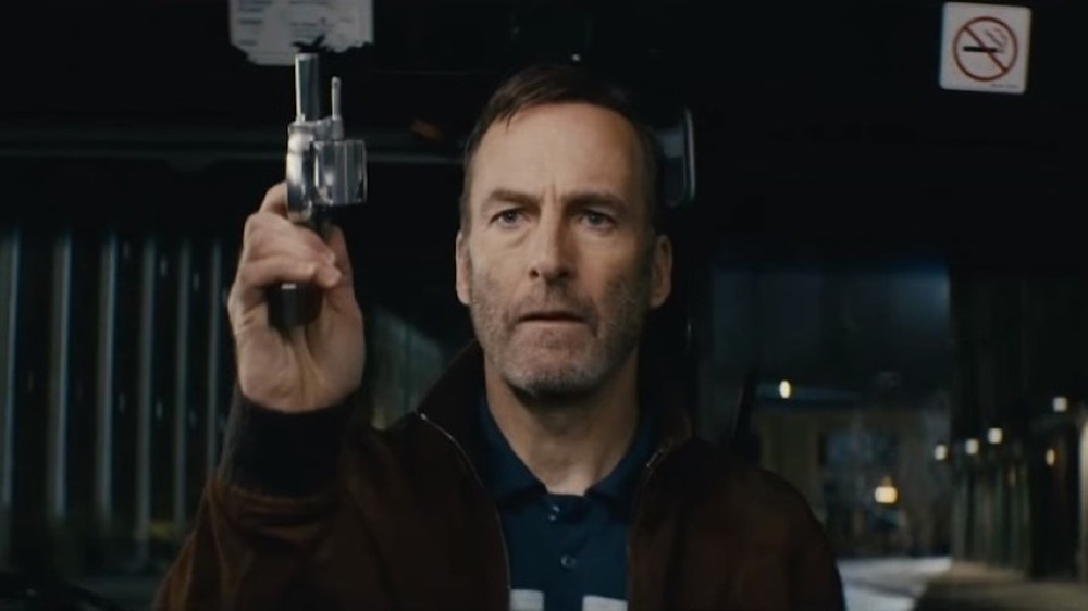 Odenkirk pointing gun at sky