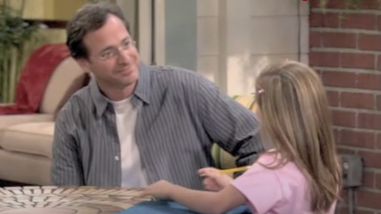 Bob Saget smiling at Genevieve Hannelius