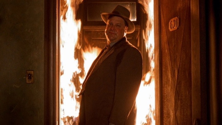 Karl Mundt standing in flaming hotel