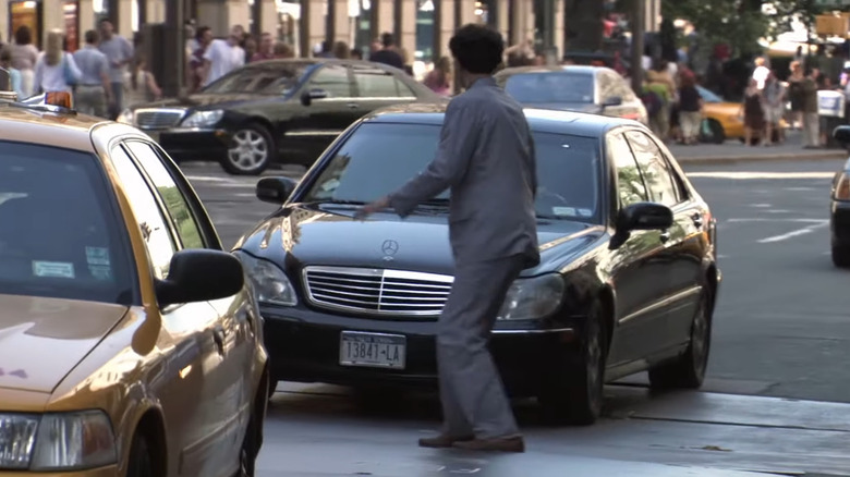 Borat crossing a busy city street