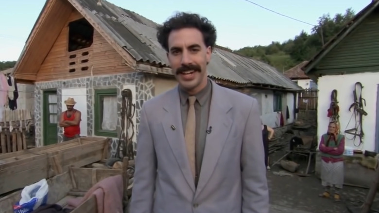 Borat smiling in his suit