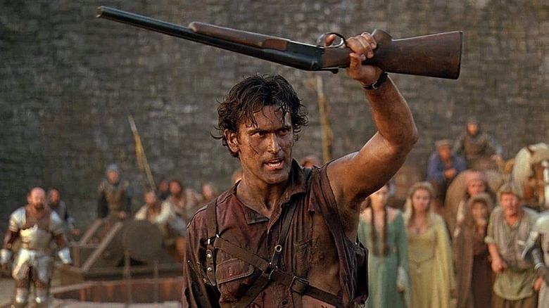 Ash Williams holds a shotgun