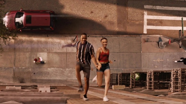 Benny and Nina running up the side of a building