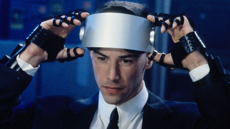 Keanu Reeves puts on goggles in Johnny Mneumonic