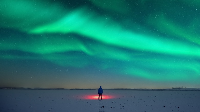 Man looking at colorful sky