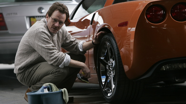 Walt washing an orange sports car 