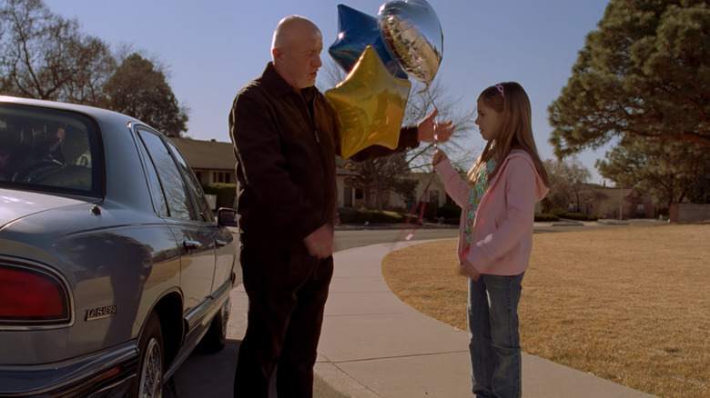 Mike hands balloons to Kaylee