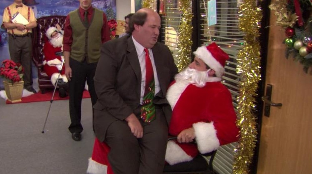 Kevin sitting on Michael's lap Office Christmas episode