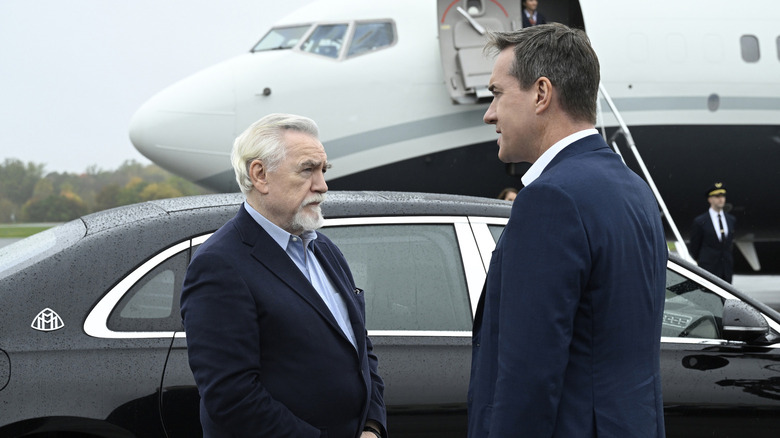 Logan and Tom standing by plane