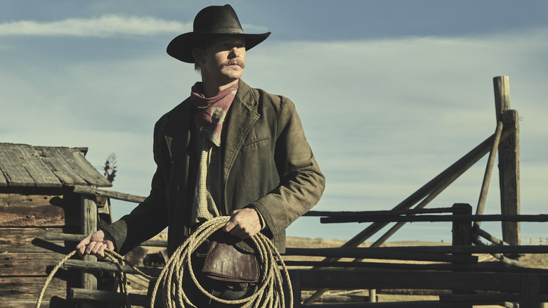 Brian Geraghty as Zane holding rope in 1923