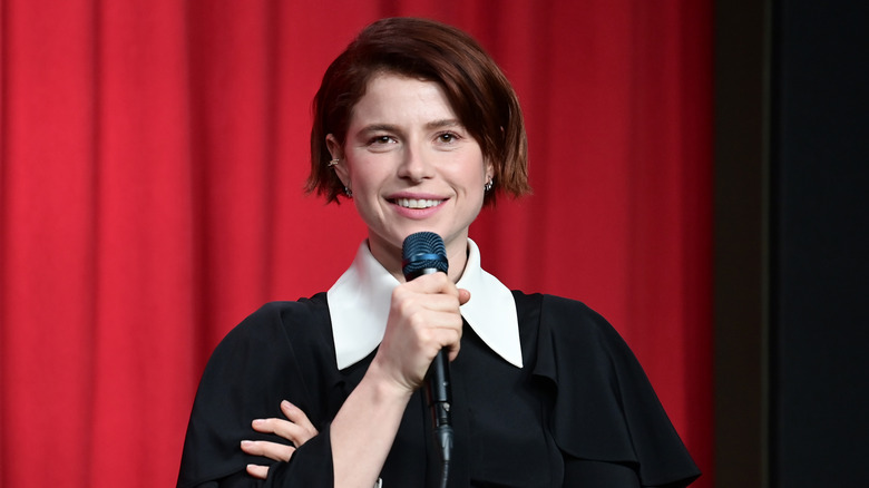 Jessie Buckley holds microphone