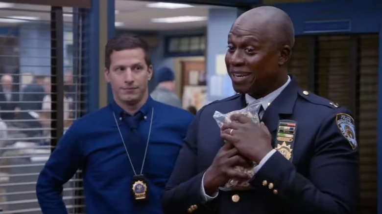 Holt smiling Peralta looks on