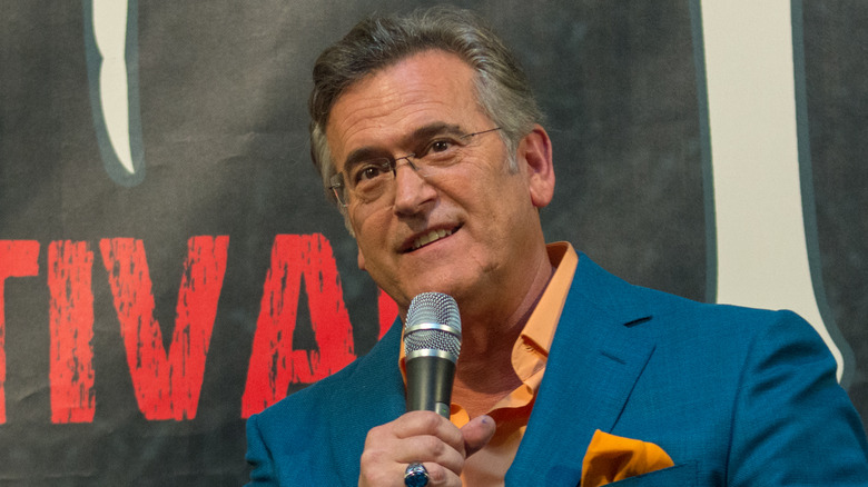 Bruce Campbell speaking into a microphone