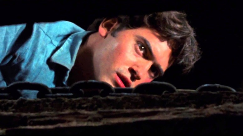 Bruce Campbell looks through cellar door