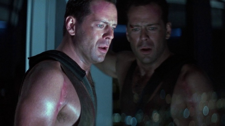 John McClane looks out a window