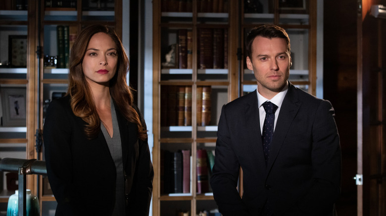 Joanna and Billy standing in front of bookshelves