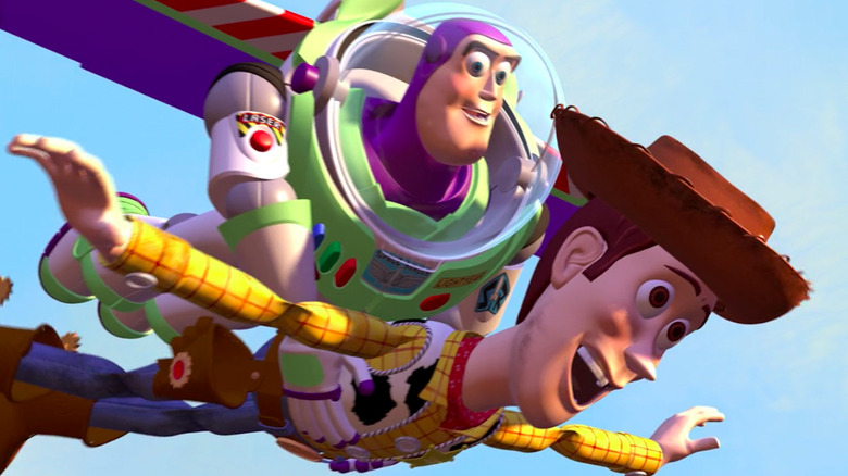 Buzz Lightyear flies while holding Woody