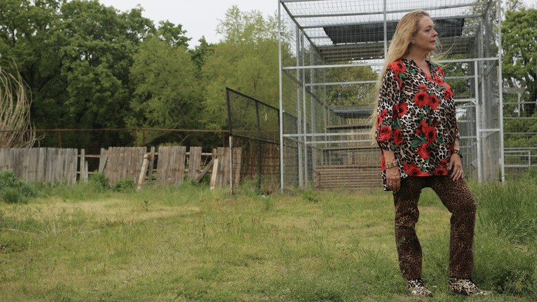 Carole Baskin outside a cage