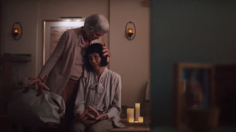 Jamie Lee Curtis caressing Michelle Yeoh's head with hotdog fingers in "Everything Everywhere all at Once"