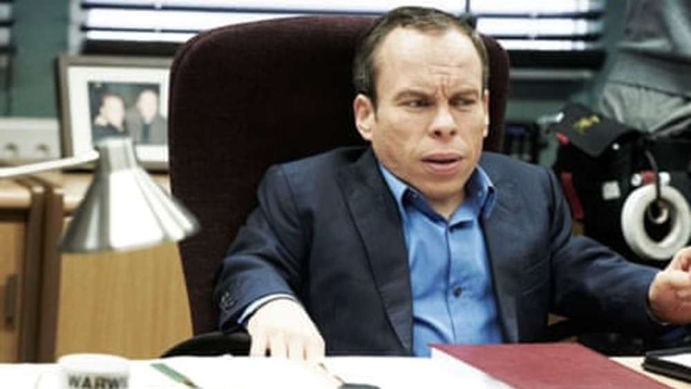 Warwick Davis grimacing