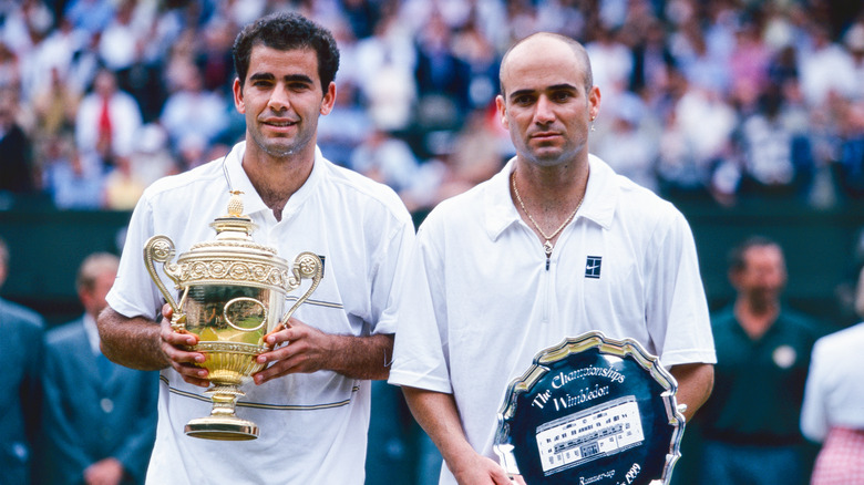 Pete Sampras and Andre Agassi holding Wimbledon trophies