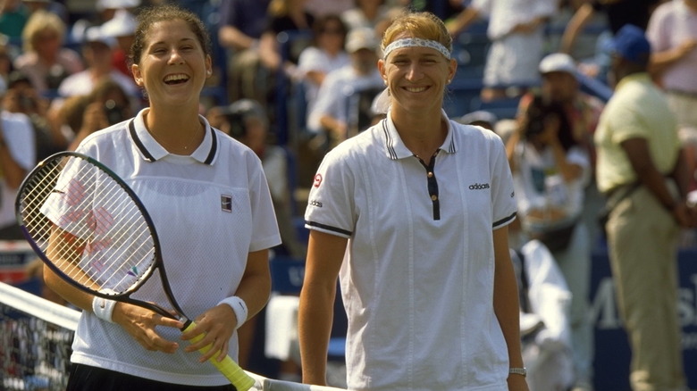 Monica Seles and Steffi Graf smiling at net