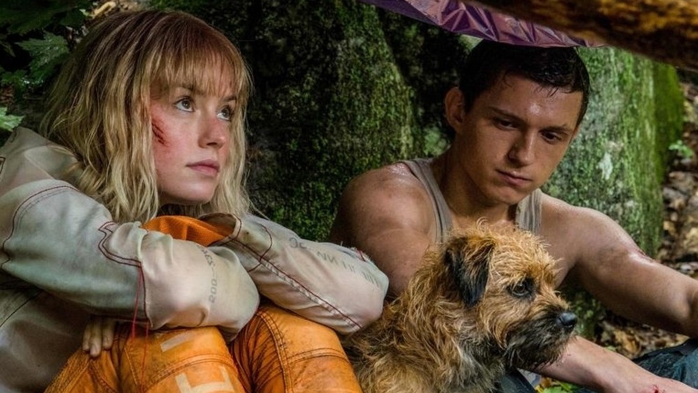 Viola and Todd Hewitt under a tarp in Chaos Walking