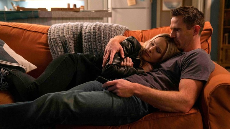 Veronica Mars cuddling up with Logan Echolls on a couch in Veronica Mars