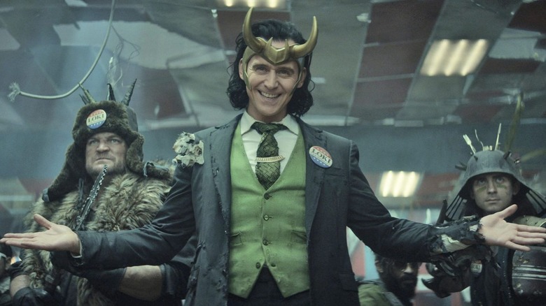 Loki opening arms and smiling