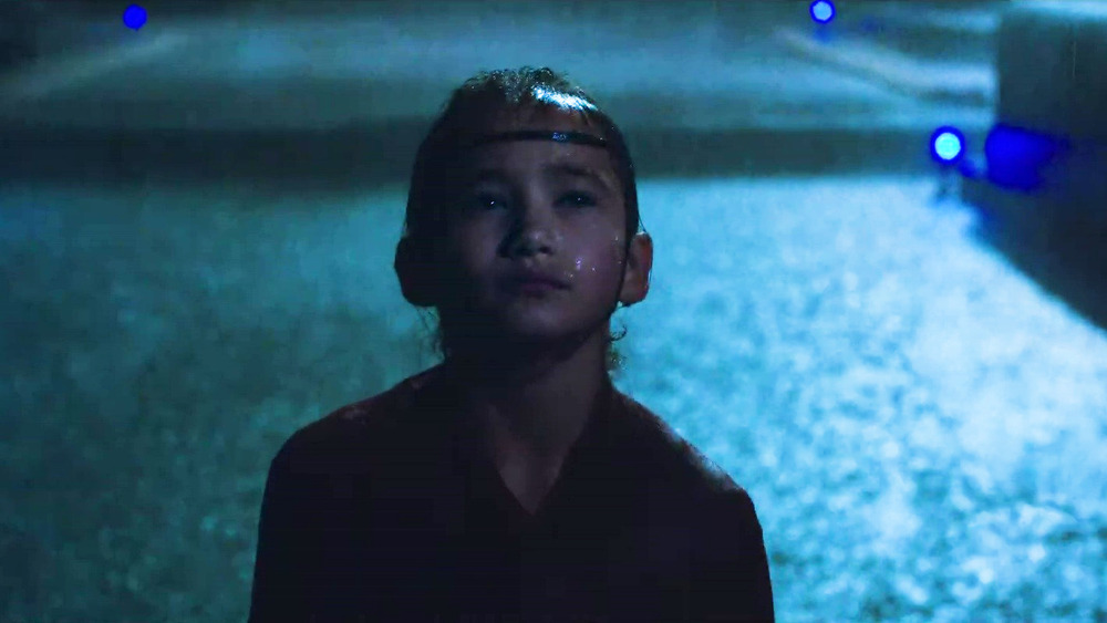 Kaylee Hottle as Jia in the rain in Godzilla vs. Kong