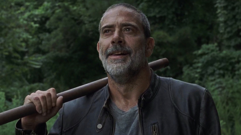 Negan holding pipe outdoors