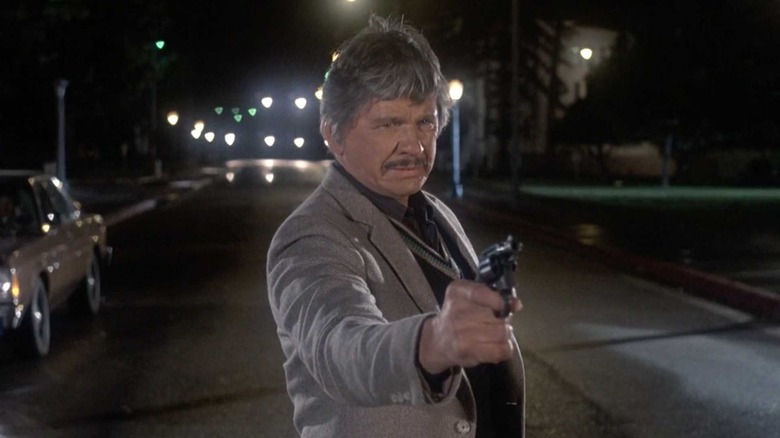 Charles Bronson points a gun